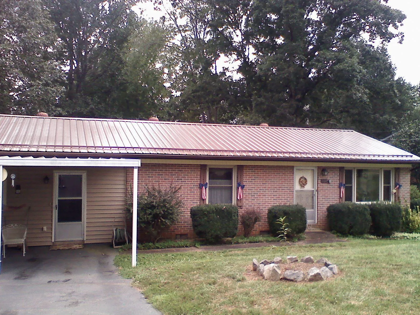 Bronze metal roof and carport on a brick ranch home — Roof Repair work by our crew in Martindale